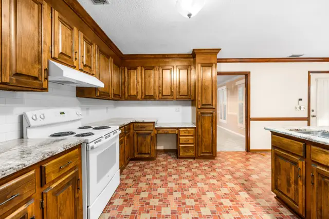 Kitchen with built-in desk and pantry cabinet