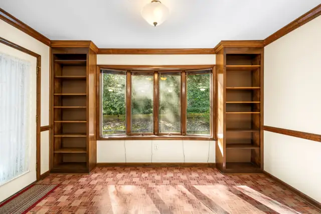 Bay window and built-in bookshelves off the kitchen