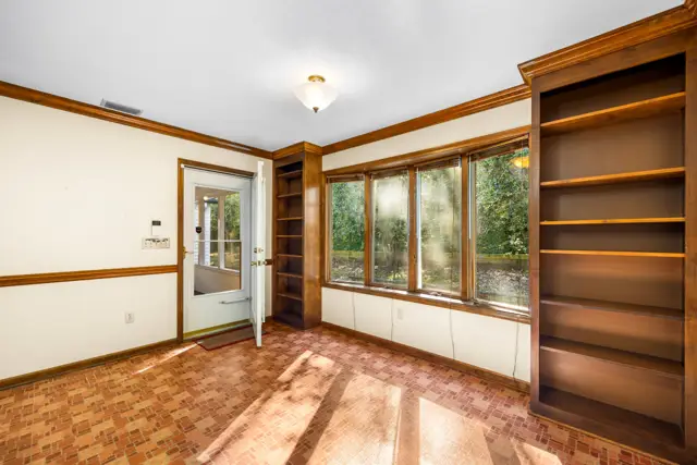 Bay window, built-ins and door to the screened porch