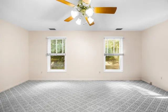 Primary bedroom windows overlooking the backyard