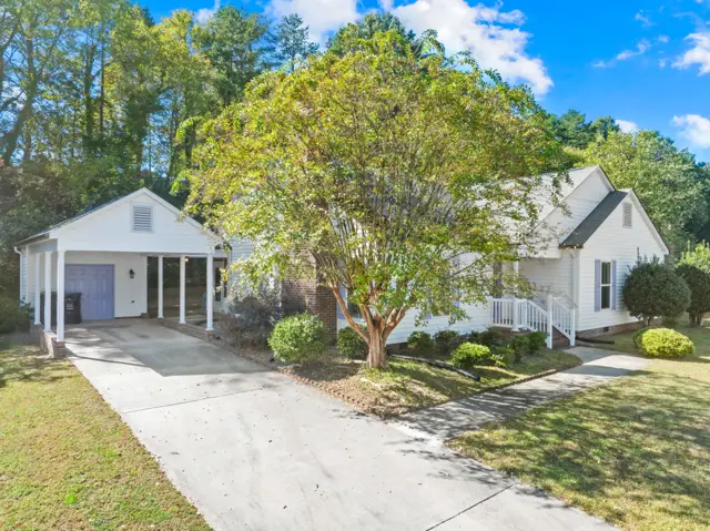 Front of the home with the carport and storage room