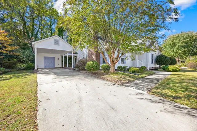 Concrete driveway leading to the covered carport
