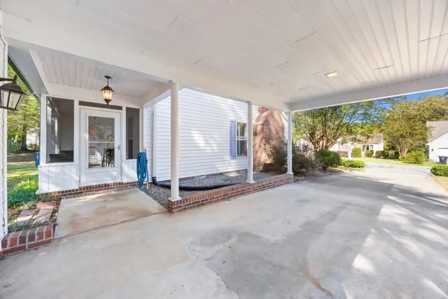Covered carport beside the screened porch entry