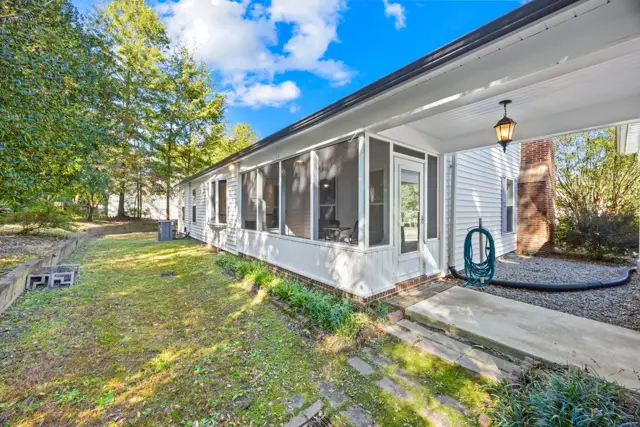 Screened porch along the side of the home